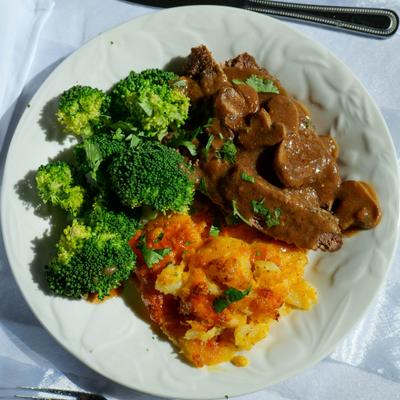 Meatloaf with sides of broccoli and potatoes, top view.