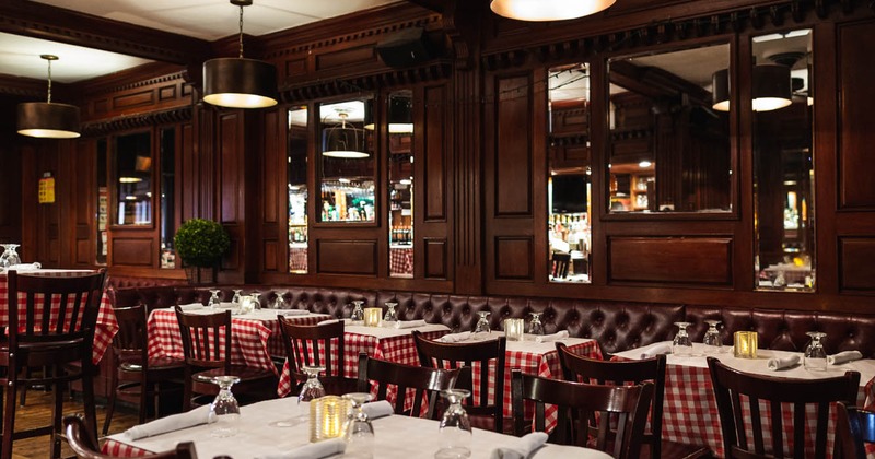 Interior, leather banquette seating, set dining tables and chairs