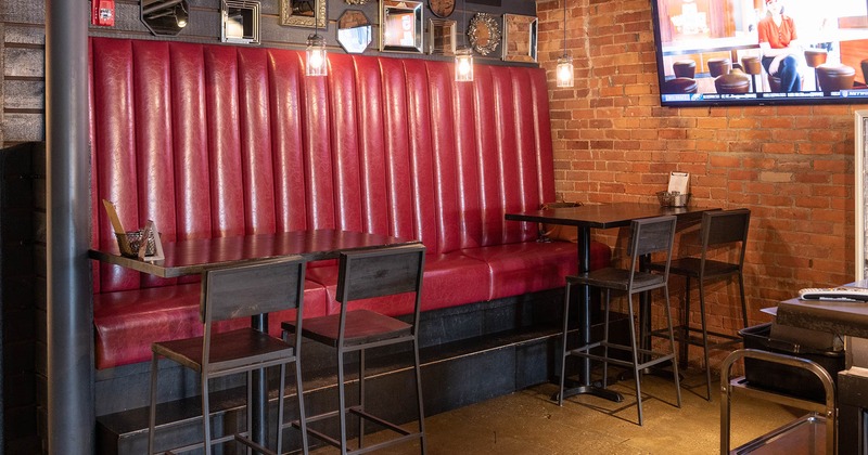 Interior, high back booth seating with two tables and chairs