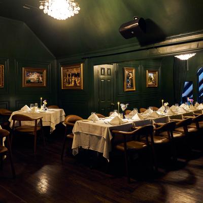 Elegant dining room with tables set for a formal dinner.