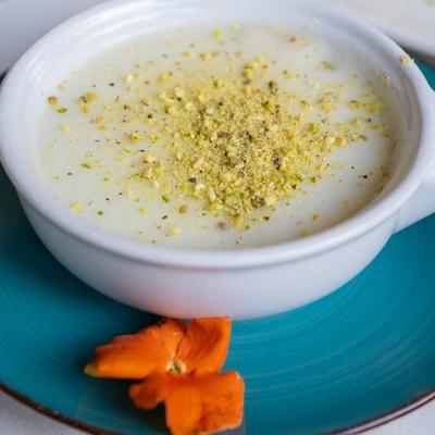 Milk pudding, topped with chopped roasted pistachios.