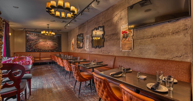 Interior, tables set for guests in dining area with pictures on the wall