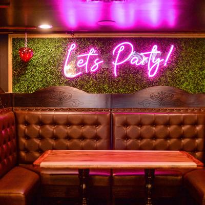 Interior, banquette seating, neon sign.
