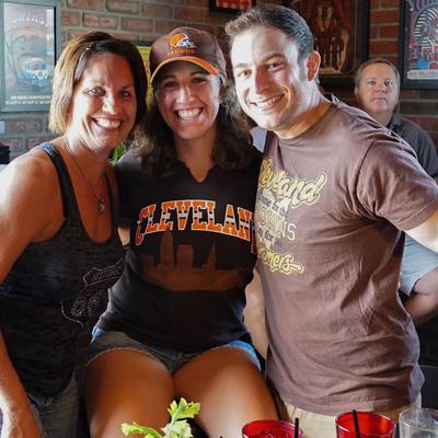 Two girls and a guy posing for a photo