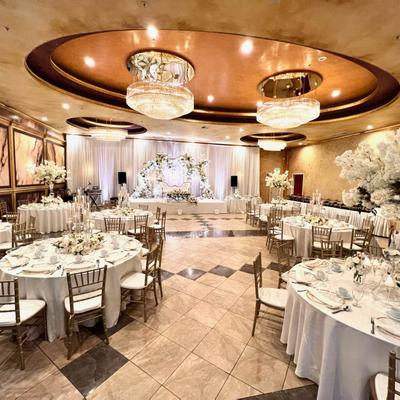 Room with white decor set for a wedding banquet.
