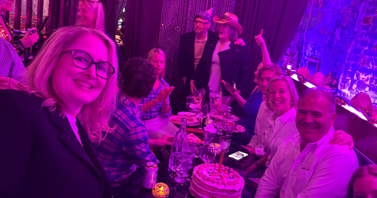 Birthday celebration with cake and restaurant guests