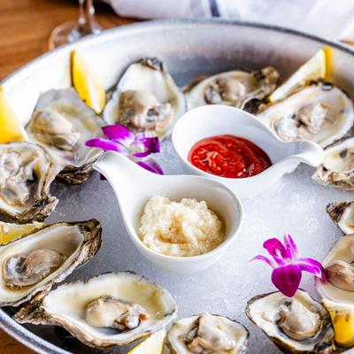 Oyster plate accompanied with a glass of white wine.