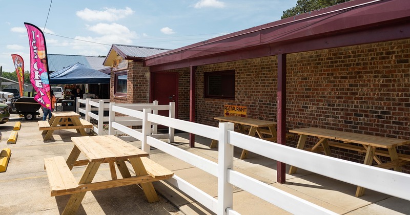 Outdoor seating area, conjoined wooden tables and benches