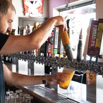 Bartender pouring  beer from tap