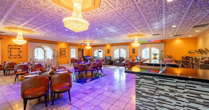 Inside, dining room, a purple embossed ceiling, crystal chandeliers, leather seating, set tables