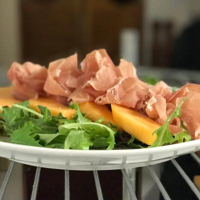 Prosciutto, melon, and lettuce salad.