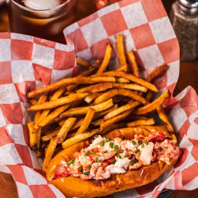 Lobster roll served with fries.