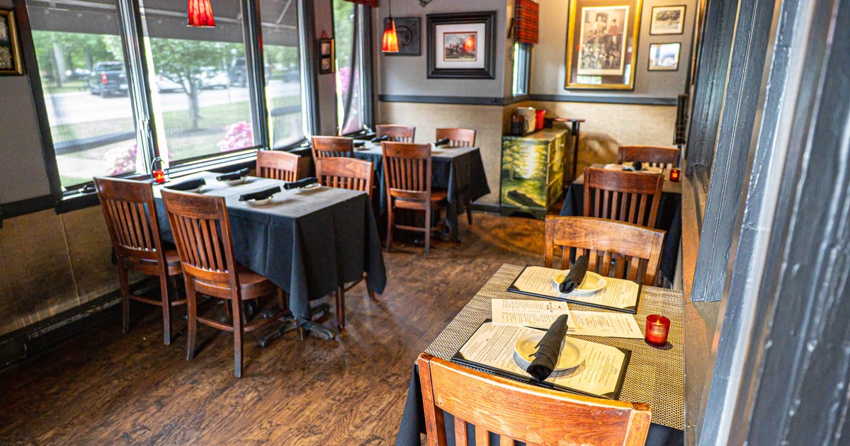 Interior of a cozy restaurant with wooden chairs and tables