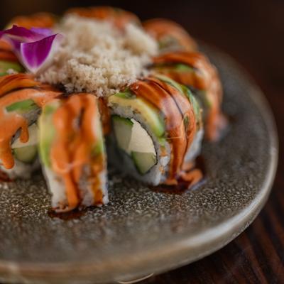 Sushi rolls with avocado, tempura flakes, spicy mayo, and eel sauce.