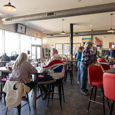 People enjoying food and drinks at a bar.