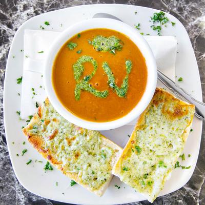 Tomato Basil Soup, served with cheesy garlic bread