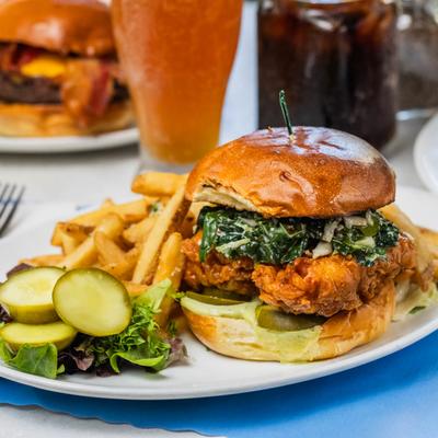 Hot Honey Buttermilk Chicken Sandwich with pickle and fries.