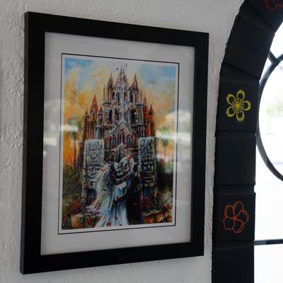 A framed art print or painting displayed on a wall.