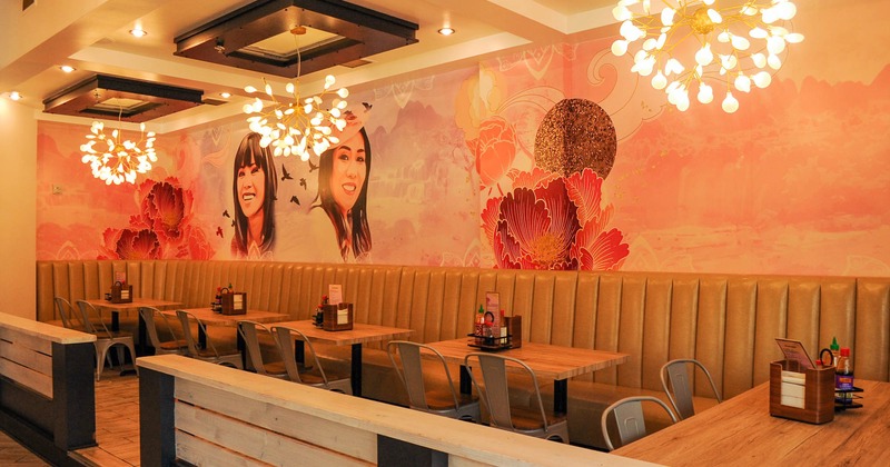 Interior, seating area by a wall decorated with mural art