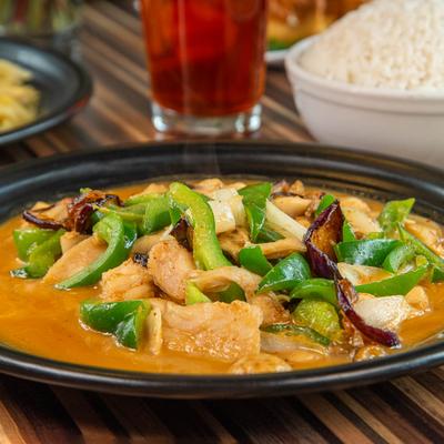 Chicken and green peppers in a creamy orange curry sauce.