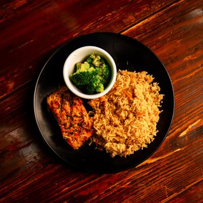 Grilled salmon served with rice and broccoli.