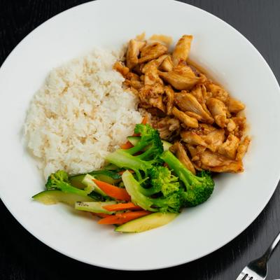 Chicken and rice plate with steamed vegetables.