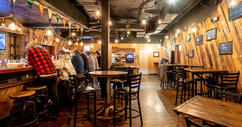 Tables with barstools on the right, and the bar also with barstools on the left