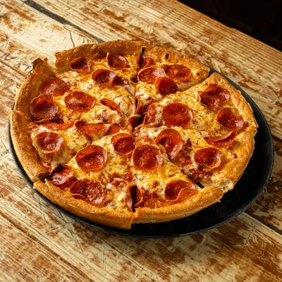 Pepperoni pizza on a wooden table.
