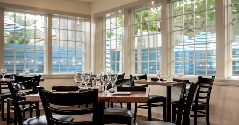 Interior, dining tables with glasses and cutlery