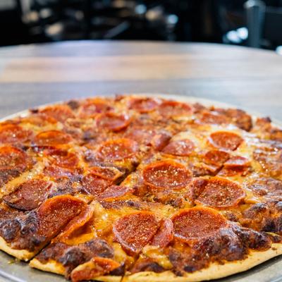 Pepperoni pizza, served on the table.