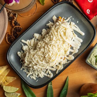 Cachapa con Queso covered in shredded white cheese.