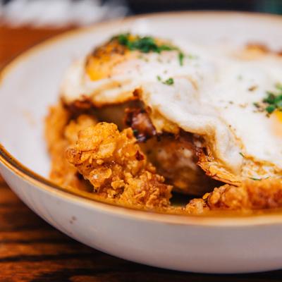 Biscuits and Gravy, with fried chicken, and sunny side up eggs.