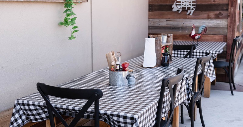 Exterior, tables with checkered tablecloths and chairs