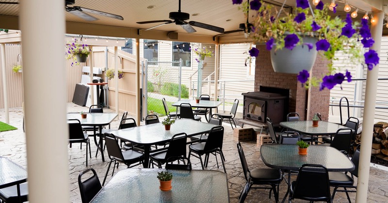 Exterior, covered seating area with tables and chairs