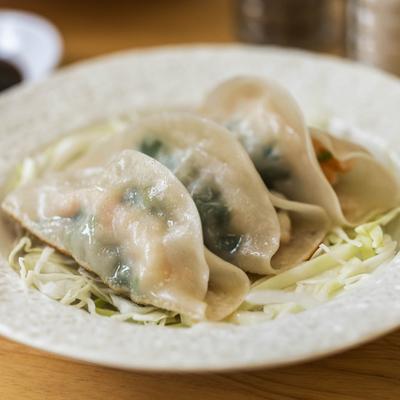 Close up of Fried dumplings with shrimp, served on a white plate.