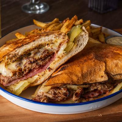 Authentic Cuban sandwich with fries and house made mustard sauce.