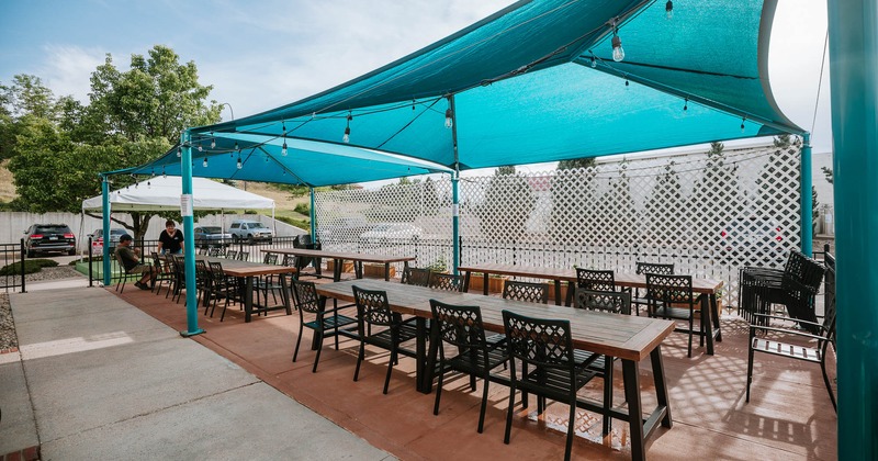 Exterior, seating area covered with awning and a frame tent stage
