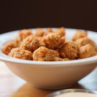 Fried okra served in a white bowl.