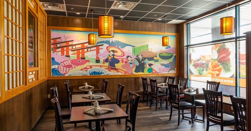 Interior, dining area, motifs from traditional prints on a wall, pendant lamps on the ceiling