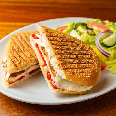 Chicken and Mozzarella panini with roasted pepper, mozzarella, and fresh vegetables.