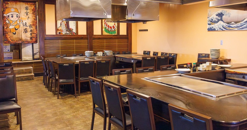 Interior, dining area, wooden top hibachi prep tables with chairs, ready for guests