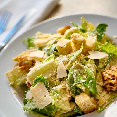 Caesar salad topped with shaved Parmesan.