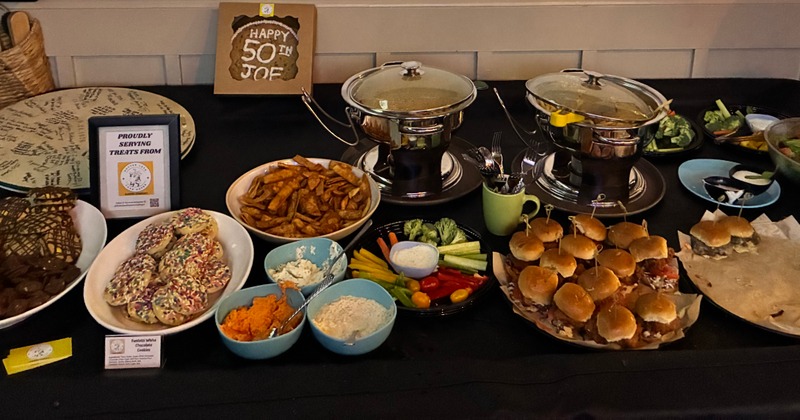 Buffet-style catering setup with finger foods, dips and vegetable platters