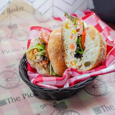 Crunchy Tuna sandwich mediterranean pickles, corn, carrots, mayo, greens and tomatoes.