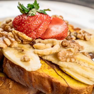 French Toast with bananas, strawberries, and walnuts.
