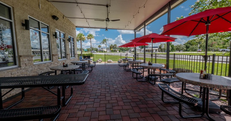 Outdoor covered seating area, tables and chairs with parasols
