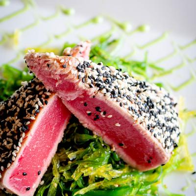 Sesame-crusted tuna served over wakame salad.