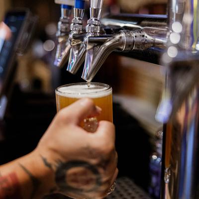 Tap beer being poured into a glass mug.