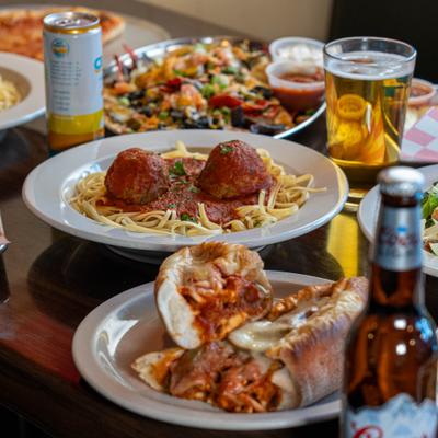 Variety of dishes served on the table with drinks.