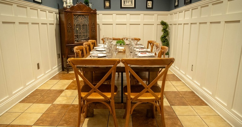 Interior, long table in dining area, pictures on the walls